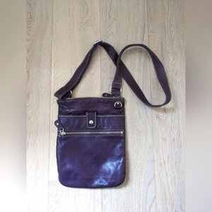 Roots small Venetian cross body purse in purple Tribe leather